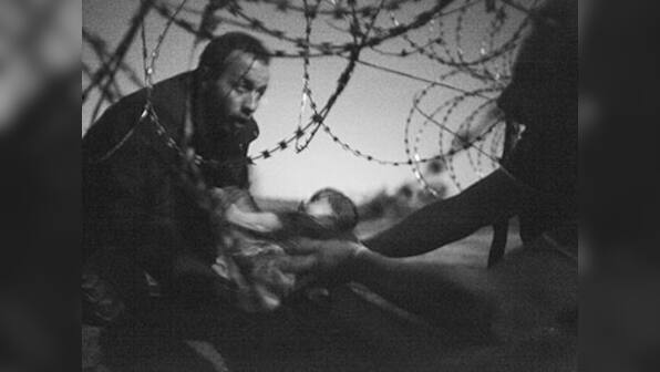 'Haunting' image of baby at barbed wire fence wins World Press Photo Award