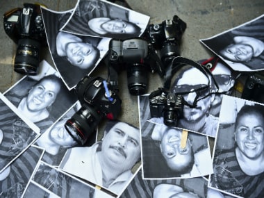 View of photos of killed journalists and cameras outside the Veracruz state representation office during a journalists protest in Mexico City on February 11, 2016. AFP