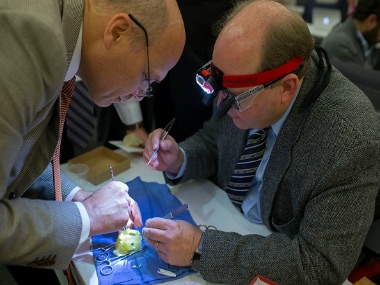 The Hospital for Sick Children head of cardiovascular surgery Glen Arsdell, left, works with Pediatric Cardiac Surgeon on a 3D printed heart in Toronto in January. GETTY IMAGES