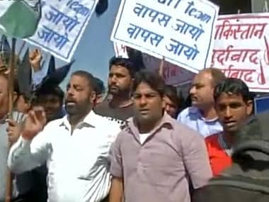Protesters holding banners at the Pathankot airbase, 29 March. IBN Live