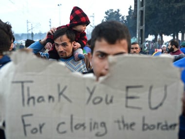 Migrants protest on 18 March 2016 at a makeshift camp at the Greek-Macedonian border. Getty Images