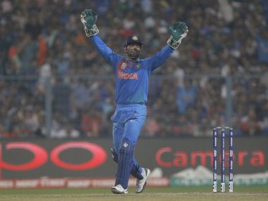 Mahendra Singh Dhoni celebrates the dismissal of Pakistan's Umar Akmal. Reuters