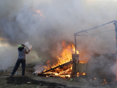 French authorities dismantle Calais 'Jungle' migrant camp after fiery clashes break out French authorities dismantle Calais 'Jungle' migrant camp after fiery clashes break out