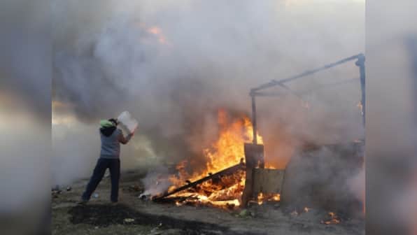 French authorities dismantle Calais 'Jungle' migrant camp after fiery clashes break out