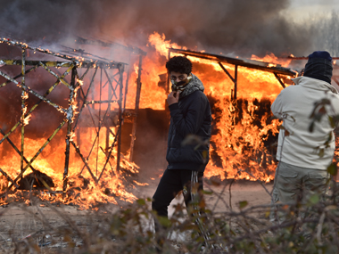 French police clash with immigrants in Calais as 'jungle' encampment demolished French police clash with immigrants in Calais as 'jungle' encampment demolished