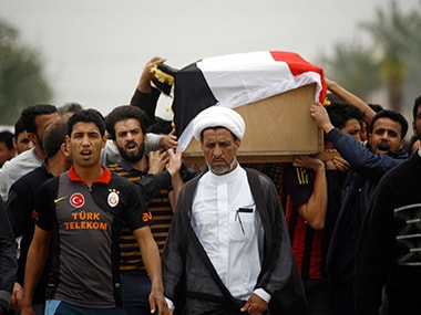 Iraqi relatives and friends mourn the victims of a suicide bomb attack.