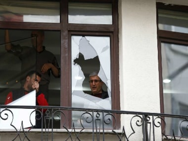 Workers remove glass from the broken window next to the scene of a suicide bombing at Istiklal street, a major shopping and tourist district, in central Istanbul. REUTERS