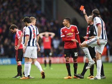 Referee Mike Dean shows the red card to Juan Mata of Manchester United during their Barclays Premier League match against West Bromwich Albion. Getty