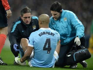Vincent Kompany receives medical treatment before leaving the pitch injured. AFP
