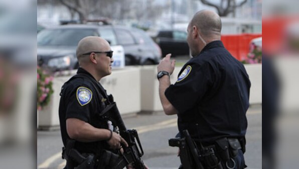 Officer dies after being shot in police car in Kansas