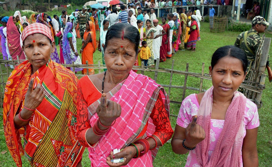 Tea tribe women show their inked fingers after casting their vote during the first phase of the Assembly Elections for Duliajan Assembly Constituency at Bordubi in Assam on Monday. PTI Tea tribe women show their inked fingers after casting their vote during the first phase of the Assembly Elections for Duliajan Assembly Constituency at Bordubi in Assam on Monday. PTI