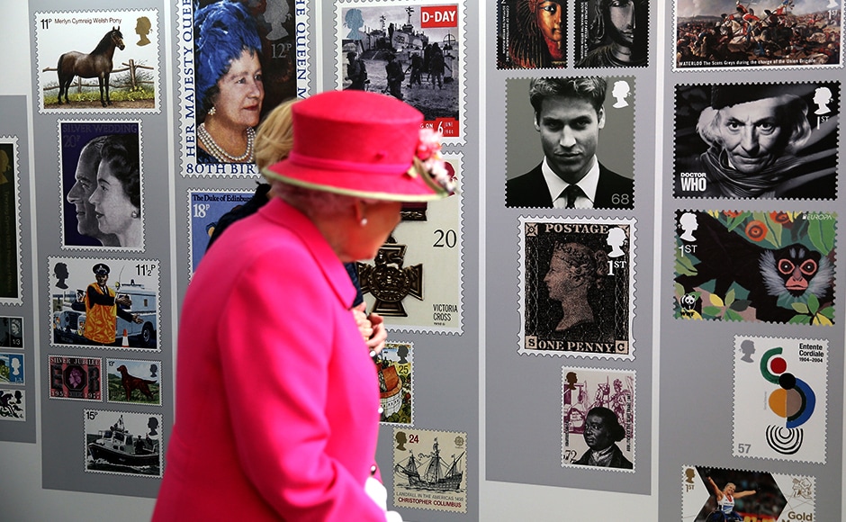 Queen Elizabeth II looks at commemorative postal stamps. Reuters Queen Elizabeth II looks at commemorative postal stamps. Reuters