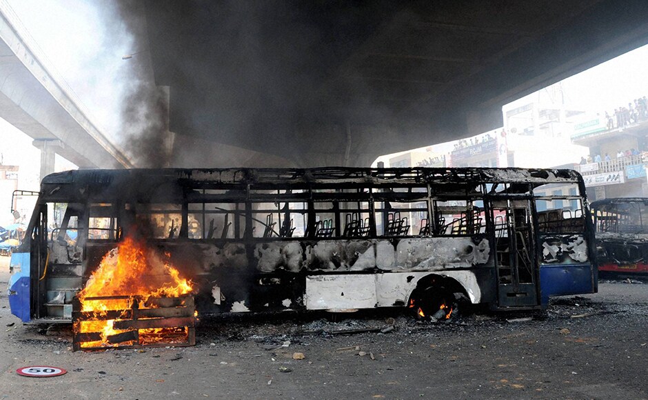 Irate protesters in the city torched two buses on Hosur Road and a truck carrying an LPG cylinder was also set on fire. Police lobbed tear gas shells at protesters in an attempt to quell the agitation. PTI Irate protesters in the city torched two buses on Hosur Road and a truck carrying an LPG cylinder was also set on fire. Police lobbed tear gas shells at protesters in an attempt to quell the agitation. PTI