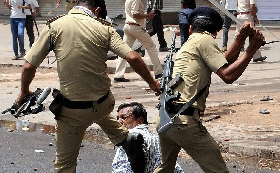 Cops charge members of the Patidar community during their Cops charge members of the Patidar community during their