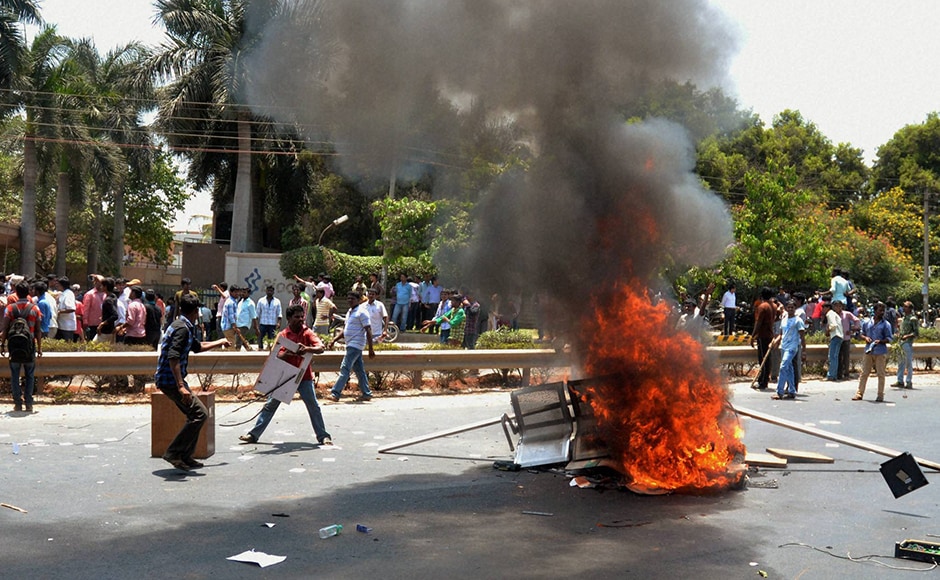 Garment workers torch furniture during the protest over EPF withdrawal norm. As tension escalated in Karnataka's capital, 62 people, including 24 policemen were injured in the violence. PTI Garment workers torch furniture during the protest over EPF withdrawal norm. As tension escalated in Karnataka's capital, 62 people, including 24 policemen were injured in the violence. PTI