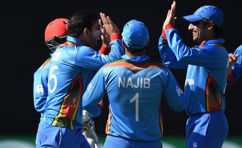 Afghanistan's Samiullah Shenwari celebrates with Mohammad Shahzad, captain Asghar Stanikzai and Najibullah Zadran.