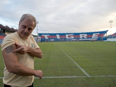 Argentina's Tigre soccer club directive Ezequiel Rocino, shows the place in his arm where he had a biochip implanted for testing, at Tigre stadium, in Buenos Aires. AP