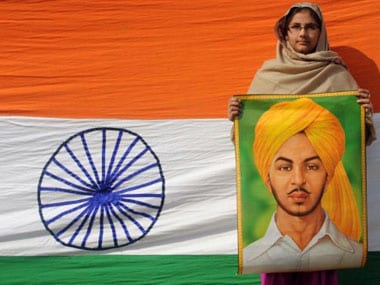 A woman holds the painting of freedom fighter Bhagat Singh. AFP