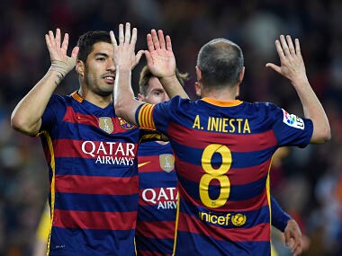 Barcelona's Uruguayan forward Luis Suarez (L) celebrates with Andres Iniesta after scoring during the match vs Real Sporting de Gijón. AFP