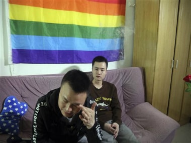 In this photo taken Tuesday, Sun Wenlin, right, sits with his partner Hu Mingliang at home a day before going to court to argue in China's first gay marriage case in Changsha in central China's Hunan province. AP