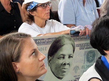 File image of a woman holding a sign supporting Harriet Tubman for the $20 bill. AP