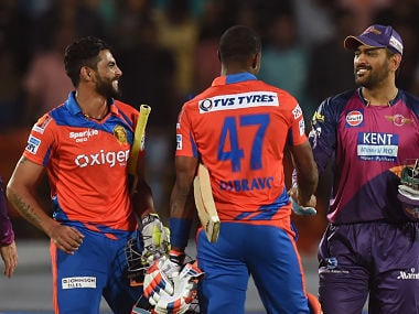 Gujarat Lions Ravindra Jadeja and Dwayne Bravo is congratulated by Rising Pune Supergiants captain Mahendra Singh Dhoni. AFP