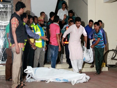 The bodies of two gay rights activists who were hacked to death are brought down from an apartment in Dhaka on. Getty Images
