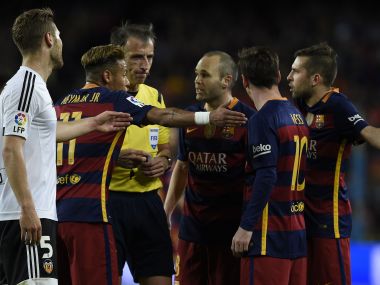 Barcelona players debate with the referee during their 2-1 loss to Valencia. AFP