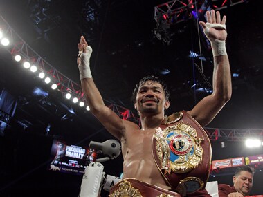Manny Pacquiao gestures to fans celebrating after defeating Timothy Bradley Jr. in a 12 round unanimous decision. AFP