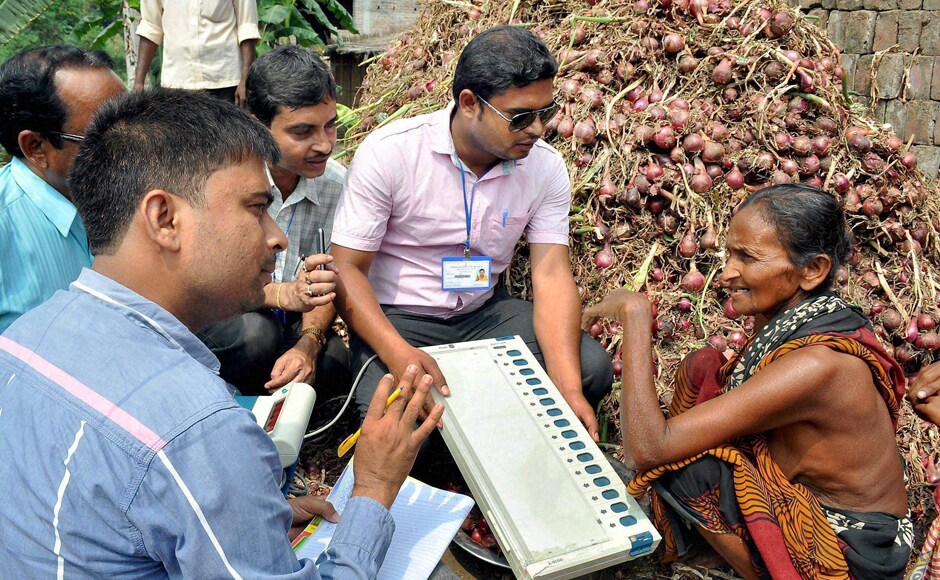 Election Commission officials demonstrate the working of the Election Voting Machine (EVM) to an elderly women farmer during a voting awareness programme for upcoming assembly elections in Murshidabad district on Monday. PTI Election Commission officials demonstrate the working of the Election Voting Machine (EVM) to an elderly women farmer during a voting awareness programme for upcoming assembly elections in Murshidabad district on Monday. PTI