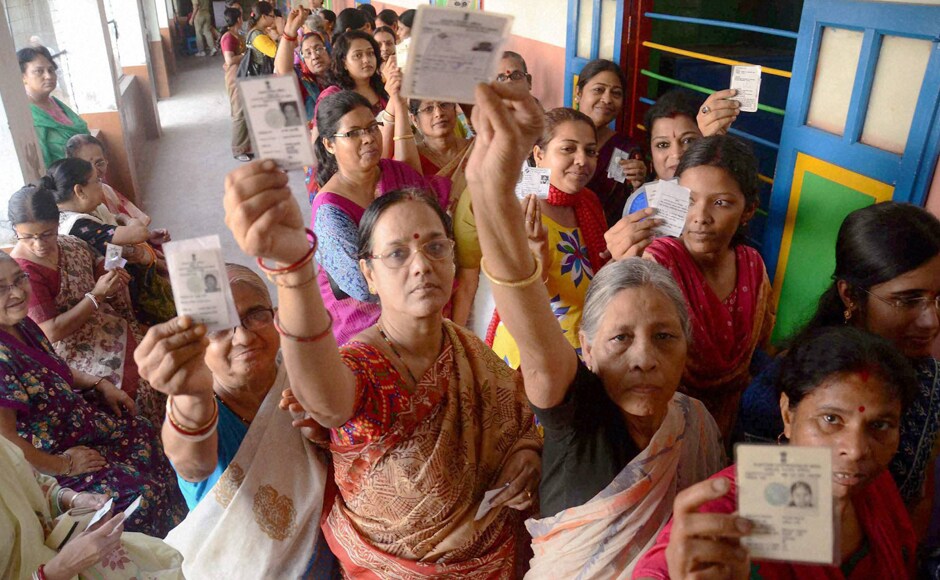 Women showing their voter cards during the first phase of the West Bengal Assembly Elections in West Medinipur on Monday. PTI Women showing their voter cards during the first phase of the West Bengal Assembly Elections in West Medinipur on Monday. PTI
