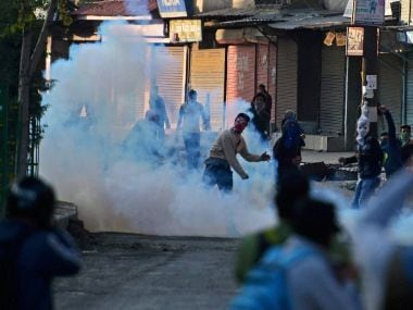 Angry youths throw stones on police during clashes which erupted after the killing of two youth allegedly in Army on Tuesday. PTI