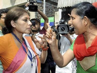BJP candidate arguing with a TMC activist at a polling booth in Kolkata. PTI