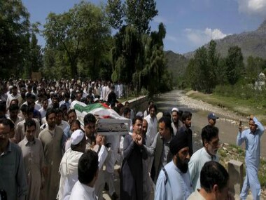 People carry the body of slain Sikh lawmaker Sardar Suran Singh during his funeral in Pir Baba village in Buner district, Pakistan, Saturday. AP