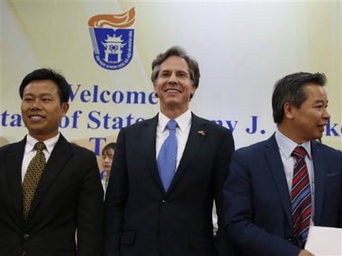 US Deputy Secretary of State Antony Blinken, center, smiles with unidentified officials of Vietnam National University during his visit, in Hanoi, Vietnam. AP
