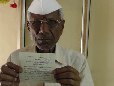 Farmer Ram Venkat Rao Hande with his insurance payment receipt