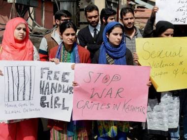 Students holding placards and a silent protest against the killing of five civilians in Handwara and Kupwara, at Lal Chowk in Srinagar on Wednesday. PTI