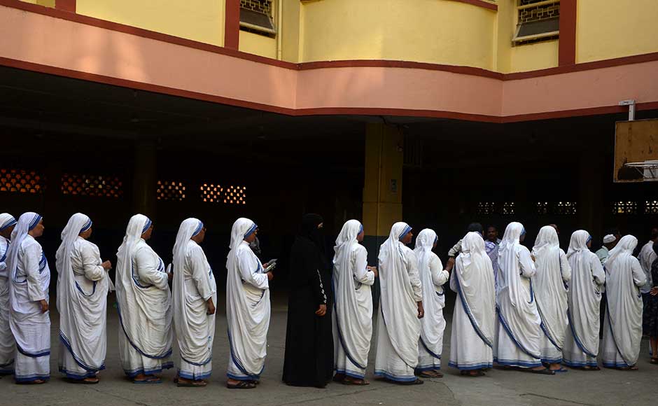 Indian Christian nuns from the Catholic Order of the Missionaries of Charity queue as they wait to cast their votes for state assembly elections inside a polling station in Kolkata on April 21, 2016. State assembly elections in West Bengal are taking place in five phases from April 4 to May 5. AFP