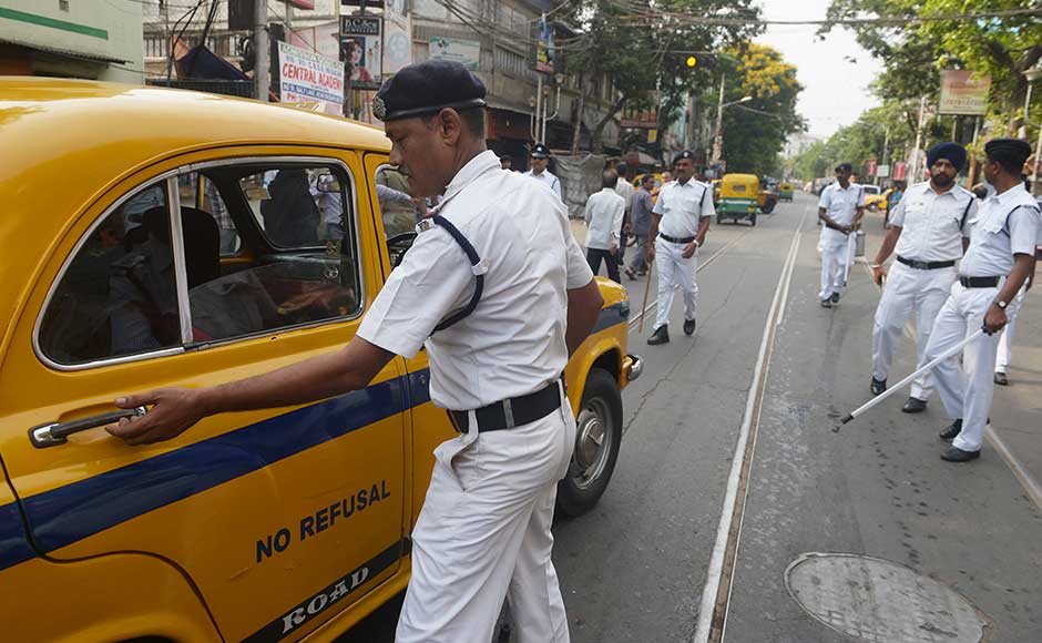 Indian police check a car next to a polling station as state assembly elections were underway in Kolkata on April 21, 2016. State assembly elections in West Bengal are taking place from April 4 to May 5. AFP