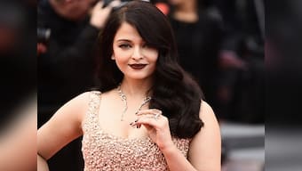 What is stopping Aishwarya Rai Bachchan from wearing 'a white shirt and jeans' at Cannes?