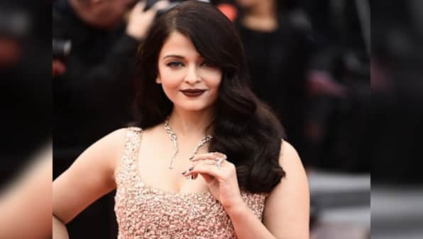What is stopping Aishwarya Rai Bachchan from wearing 'a white shirt and jeans' at Cannes?