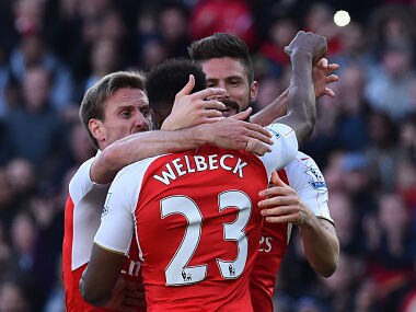 Arsenal players celebrate after scoring against Norwich in the Premier League. AFP