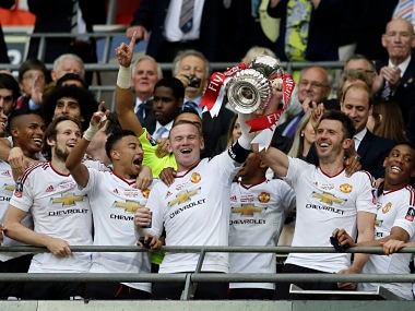 Manchester Uniteds Wayne Rooney lifts the FA Cup trophy at Wembley. AP