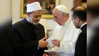 Pope Francis and the Grand Imam exchange hugs and gifts at Vatican