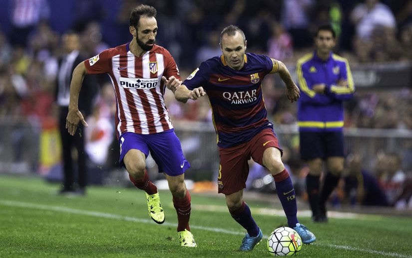 Spanish players Andres Iniesta and Juanfran during a La Liga match. Getty Images