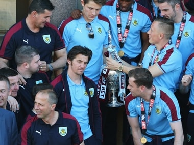 A medalless Joey Barton (C) looks on alongside team mates as Sky Bet Champions Burnley are presented with the Championship trophy. Getty