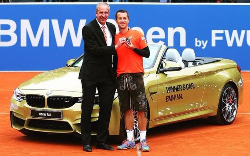 Philipp Kohlschreiber gets a typical Bavarian leather trousers and a BMW car as a present. Image courtesy: Twitter/@BMWOpenbyFWUAG