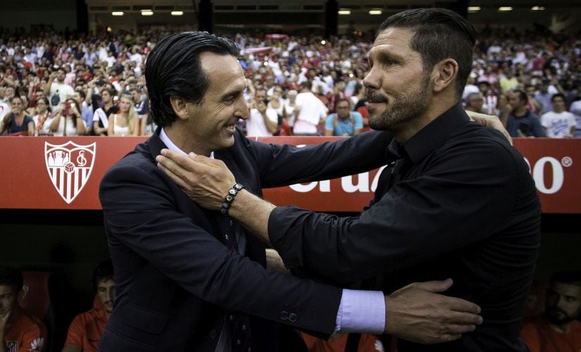 Head coach Unai Emeri of Sevilla FC embraces head coach Diego Pablo Simeone of Atletico de Madrid. Getty Images