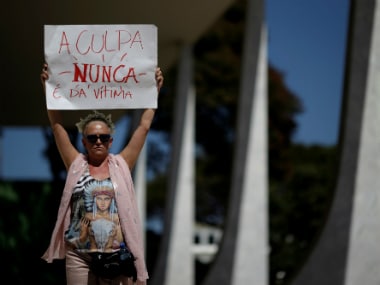 Demonstrators attend a protest against rape and violence against women in Brasilia, Brazil on Sunday. Tha placard reads, "Guilt is never of the victim". REUTERS