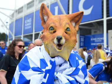 A Leicester City supporter wearing a fox mask, arrives at the stadium ahead of the English Premier League football match between Leicester City and Everton. AFP
